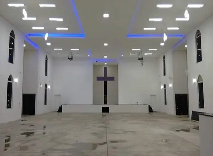 Interior de templo com teto alto e paredes claras